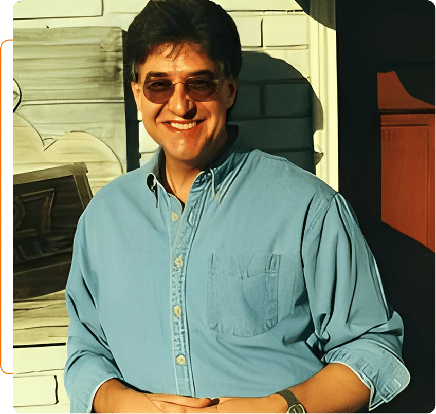 Smiling person in sunglasses and blue shirt.